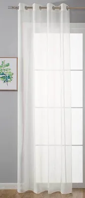 A white sheer curtain hangs in front of a window with a framed picture on the wall to the left.