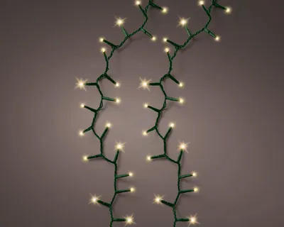 Two strands of soft gold LED lights with green wires are shown against a plain background.