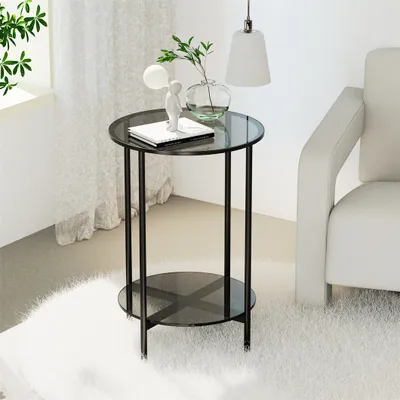 A modern glass and metal side table with decorative items on top, placed on a fluffy rug next to a chair.