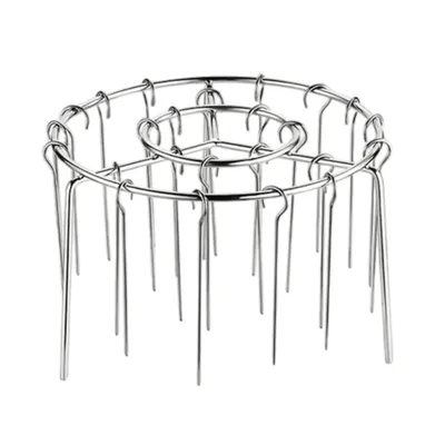 A silver metal grill rack with multiple prongs, designed for use in an air fryer.