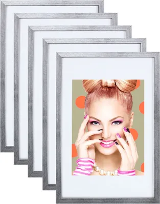 A set of silver picture frames with a woman's portrait in the foreground.