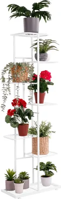 A white metal plant stand with multiple tiers, displaying various potted plants.
