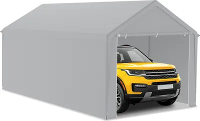 A yellow SUV is parked inside a gray tent garage.