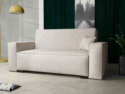 A modern living room setting with a sofa, lamp, and artwork.