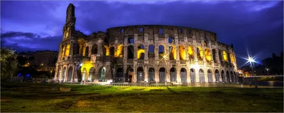 Produktbild von Wallario Poster - Italien bei Nacht - Kollosseum in Rom, beleuchtet am Abend, Kunstdruck Größe: 80 x 200 cm