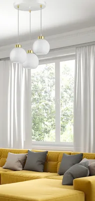 A modern living room with a yellow sectional sofa and a large window with white curtains.