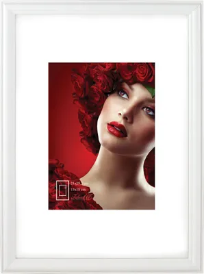 A white picture frame with a matted photo of a woman with red roses in her hair.