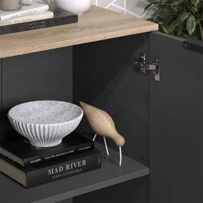 A close-up view of a shelf in a cabinet, showing decorative items and books.