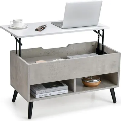 A lift-top coffee table with storage, a laptop, and a coffee cup on top.