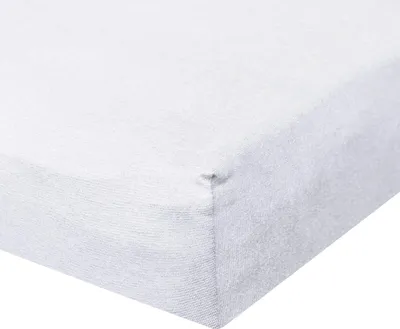 A close-up view of the corner of a white fitted sheet.