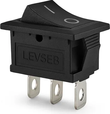 A black rocker switch with silver terminals is shown against a white background.