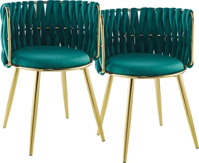 Two teal velvet chairs with gold legs against a white background.