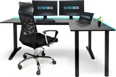 A black L-shaped gaming desk with two monitors, a laptop, and a chair.