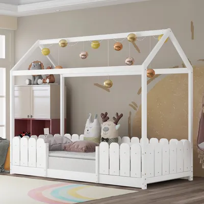 A child's bed with a house frame, decorated with hanging ornaments and plush toys.