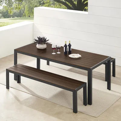 An outdoor dining set consisting of a table and two benches on a patio.