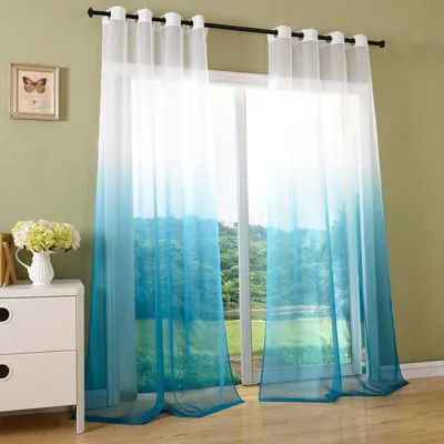 A room with a window covered by gradient curtains, a dresser, and a framed picture.