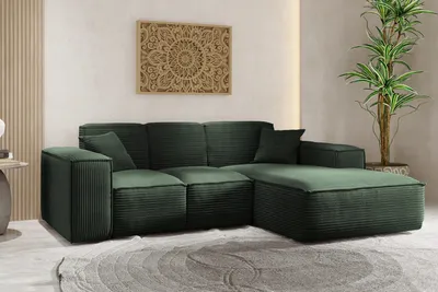 A dark green corduroy sectional sofa in a modern living room.