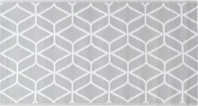 A close-up view of an outdoor rug with a geometric pattern.