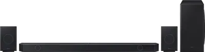 A black soundbar system with two satellite speakers and a subwoofer, all on a white background.
