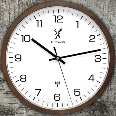 A close-up shot of a wooden wall clock with a white face and black hands, set against a textured background.