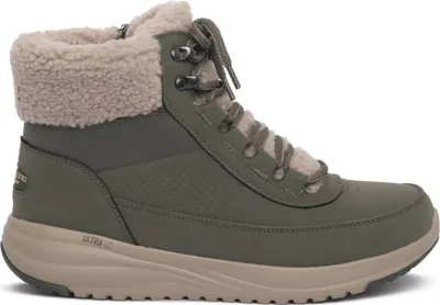 A single green boot with beige trim and sole, shown from the side against a white background.