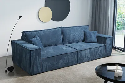 A blue corduroy sofa in a living room setting.