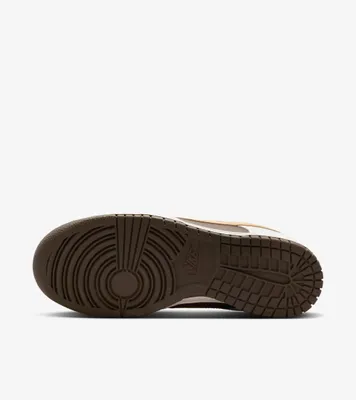 The sole of a Nike Dunk Low sneaker is shown against a white background.