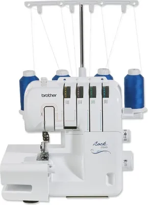 A white Brother overlock sewing machine with blue thread spools on a white background.