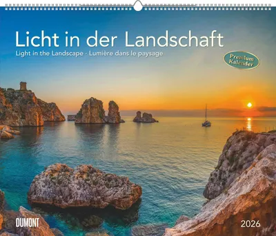 A scenic coastal landscape at sunset, with rocky islands and a sailboat on the water. The image is the cover of a calendar.