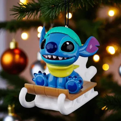 A Stitch Christmas ornament on a tree.