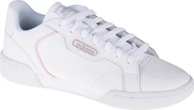A white Adidas sneaker with pink accents.