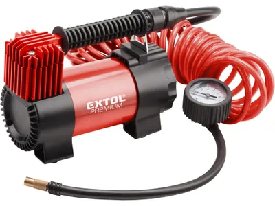 A red and black car air compressor with a pressure gauge and coiled hose, presented on a white background.