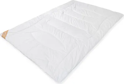 A white duvet is laid out flat on a white background.