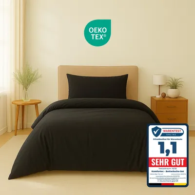 A black duvet cover and pillowcase set displayed on a bed.