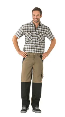 A man wearing work pants and a plaid shirt, standing against a white background.