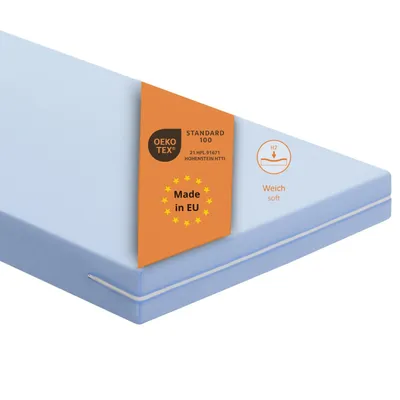 A light blue mattress with an orange label showing certifications and origin.