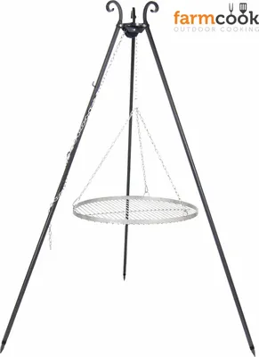 A black metal tripod grill stand with a circular stainless steel grill grate suspended by chains.