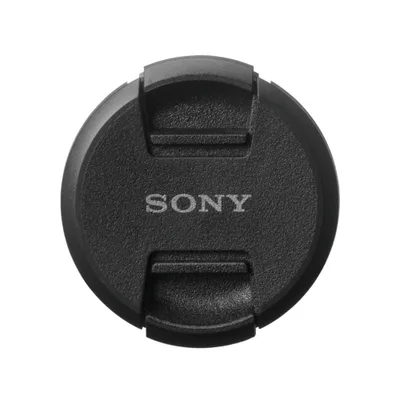 A black Sony lens cap is shown against a white background.
