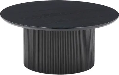 A round black coffee table with a fluted base.