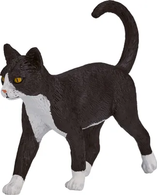 A black and white cat figurine standing on a white background.