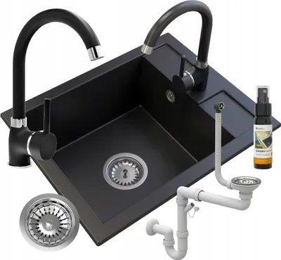 A black granite kitchen sink with two faucets and plumbing accessories, presented on a white background.