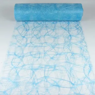 A roll of light blue decorative mesh fabric with a swirling pattern, partially unrolled on a white surface.