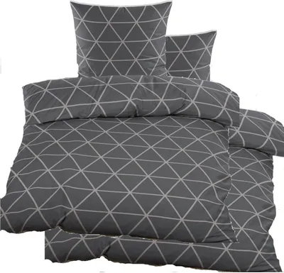 A stack of folded bedding with a geometric triangle pattern.