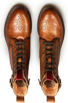 A top-down view of a pair of brown leather lace-up boots.