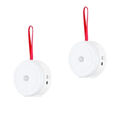 Two white, round motion-activated night lights with red hanging straps are shown against a white background.