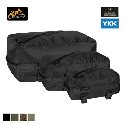 Three black packing cubes of varying sizes are arranged diagonally on a white background.
