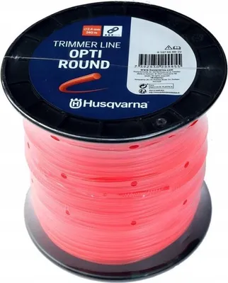 A spool of red trimmer line manufactured by Husqvarna.