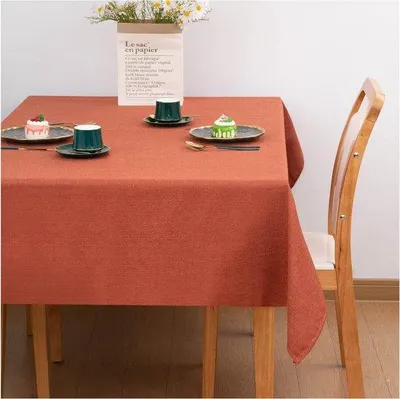 Imagen del producto de Mesa Unyqoos® de color naranja oscuro, 145 x 180 cm, rectangular, aspecto de lino (poliéster y lino), 300 g/m², repelente al agua con efecto loto