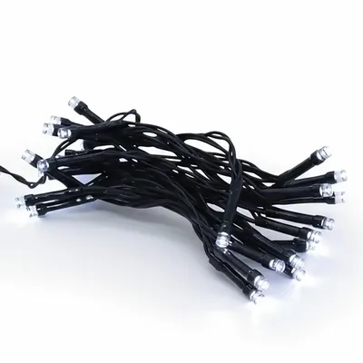 A pile of black LED string lights with white LEDs on a white background.