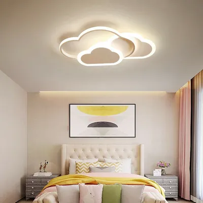 A bedroom with a bed, nightstands, and a cloud-shaped ceiling light.